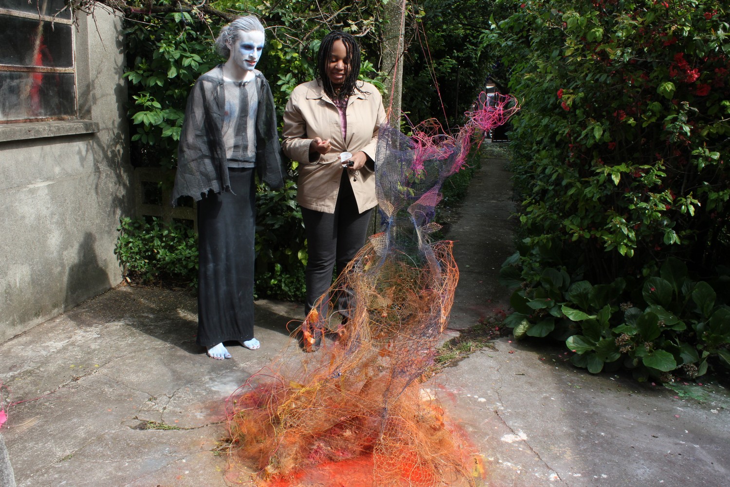 Maquillage et costume de l'artiste Arnaud Degouy devant une sculpture en grillage et fil de fer de l'artiste Orane Fiora